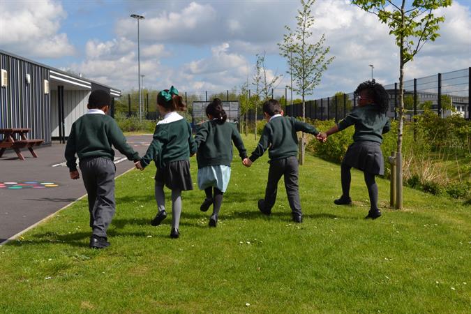 Children holding hands outside.JPG